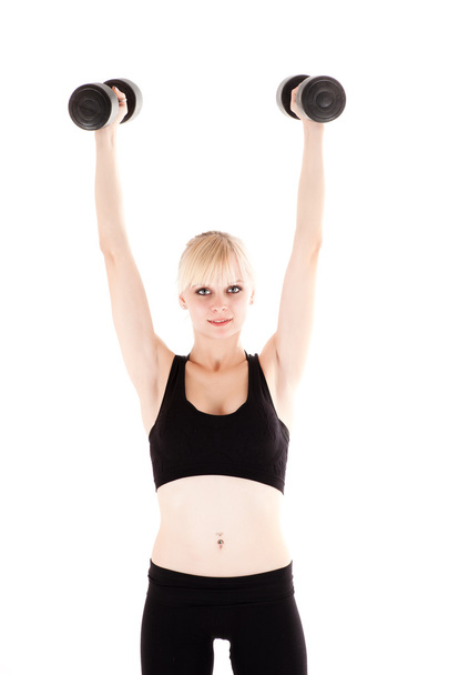 Woman is engaged with dumbbells - Photo, image