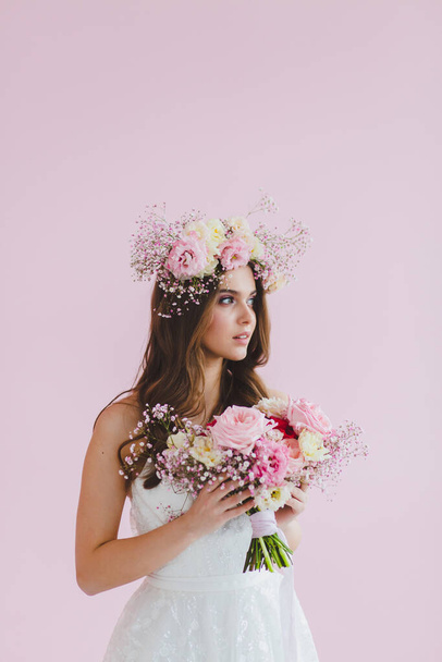 Close-up portrait of beautiful bride with flower wreath on her head - Photo, image