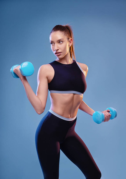 Young sporty woman posing in studio  - Fotó, kép