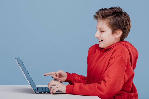 happy excited boy pointing finger at laptop - Fotografie, Obrázek