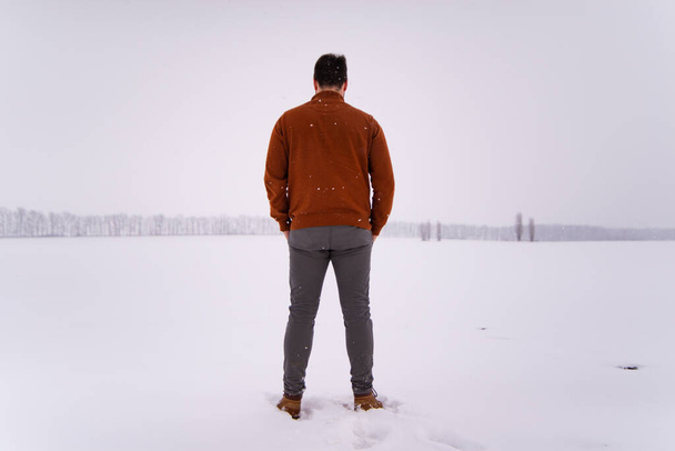 man standing outdoors in snowed field winter season - Photo, Image