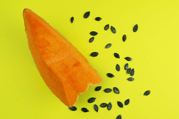 Pumpkin and Pumpkin seeds on a yellow background. - Photo, Image