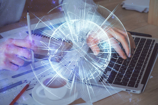 Double exposure of businessman working on laptop on background. International business hologram in front. Concept of success. - Foto, Imagem