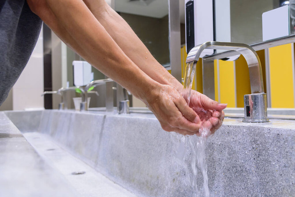 Wash hands by water / protect  your health from disease - 写真・画像