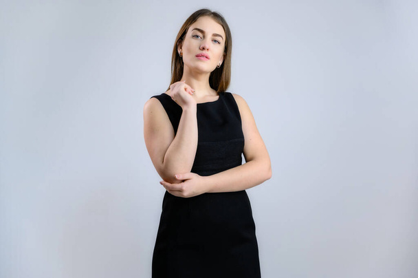 Universal concept. Photo of a pretty Caucasian business woman in a black dress on a white background. - Zdjęcie, obraz