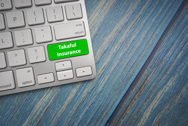 TAKAFUL INSURANCE text on button of computer keyboard. Business and Islamic concept - Photo, Image