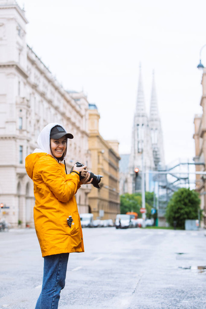 photographer tourist taking picture of city street with votive church on background vienna austria - Photo, Image