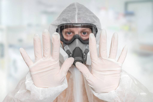 Scientist with FFP3 respirator mask is showing STOP gesture - SARS, MERS, CORONAVIRUS concept - Photo, Image