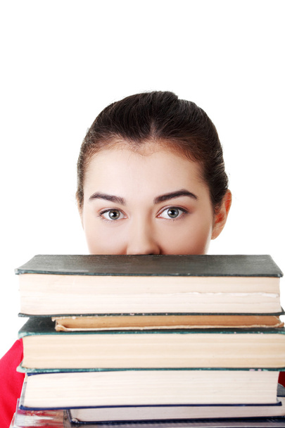 Attractive young woman with stack of books. - Foto, afbeelding