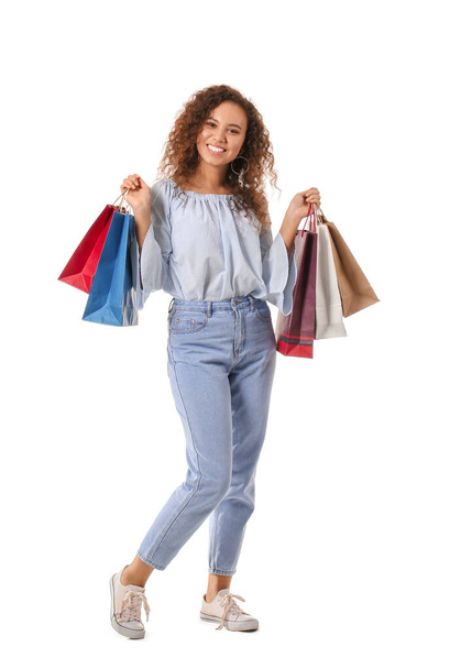 Beautiful young woman with shopping bags on white background - Foto, imagen
