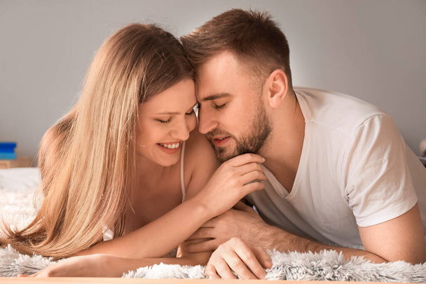 Happy young couple in bedroom - Photo, Image