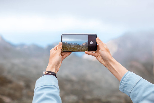 Photographing mountains on phone - Photo, image