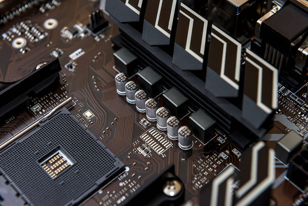 Computer motherboard on dark background, close up - Fotó, kép