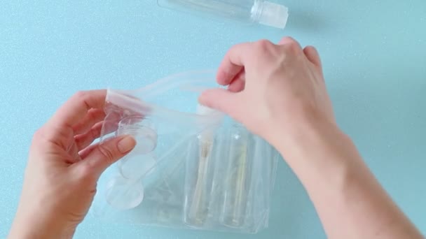 a woman takes plastic bottles from a bag - 映像、動画