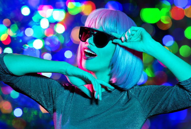 happy woman in pink wig and sunglasses dancing - Foto, Bild