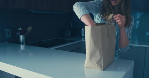Young woman unpacking her shopping of vegetables - Video