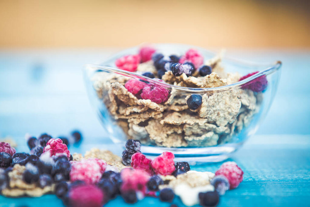 Organic cereals on blue wooden background - Foto, imagen