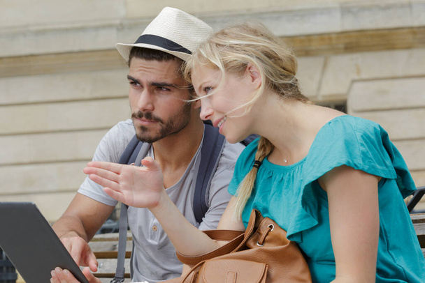 a portrait of couple organizing their sightseeing - Photo, Image