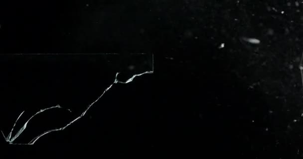 Broken cracks glass fracture effect texture isolated abstract black background. Bullet cracked window with big hole screen mirror weapon shot. - Footage, Video