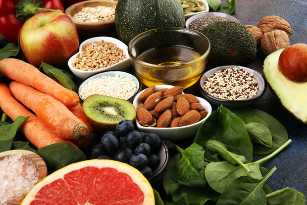 Healthy food clean eating selection: fruit, vegetable, seeds, superfood, cereals, leaf vegetable on background - Photo, Image
