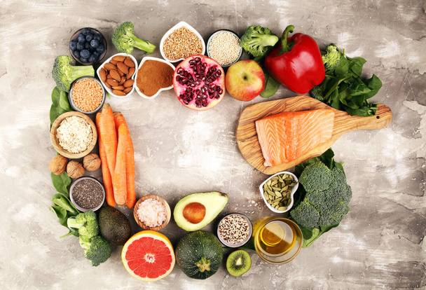 Healthy food clean eating selection: fish, fruit, vegetable, cereal, leaf vegetable on background - Foto, Imagen