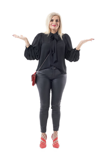 Bizonytalan, jól öltözött középkorú nő vállvonogatás felemelt kézzel dilemma. Teljes test hossza elszigetelt fehér háttér. - Fotó, kép