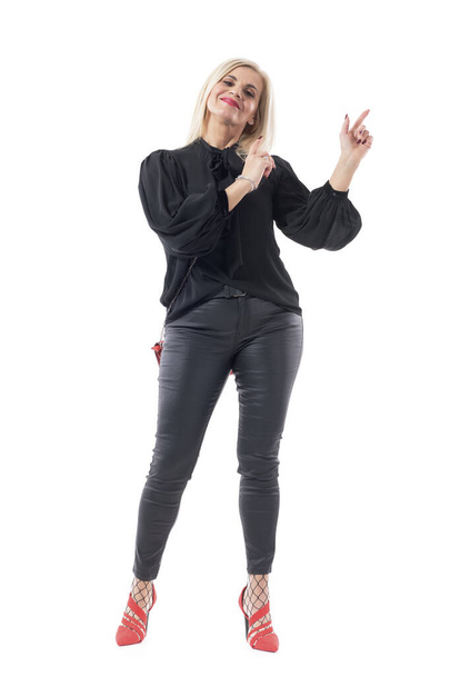 Happy satisfied middle aged lady well dressed woman pointing finger up showing empty space. Full body length isolated on white background. - Photo, Image
