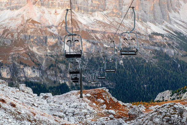 Ski lifts along the ski slope near the Cinque Torri mountains near the famous town of Cortina d'Ampezzo, Dolomites Mountains in Italy - Photo, Image
