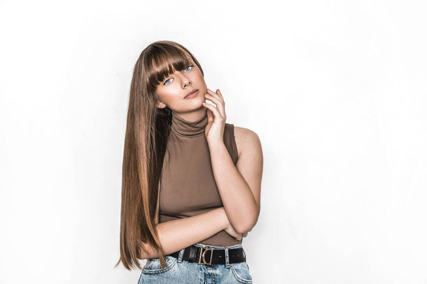 Beauty portrait of young natural model with perfect long healthy shiny hairstyle isolated on white posing in studio. Pretty girl with stylish smooth haircut. Hairstyle concept.Teenager hair model - 写真・画像
