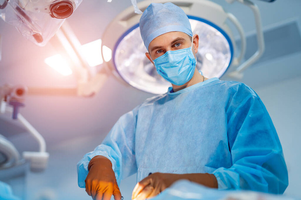 Process of surgery operation using medical equipment. Surgeon in operating room with surgery equipment - Photo, Image