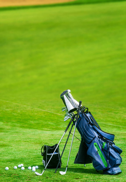 Bag of golf clubs on the golf course vertical copy space - 写真・画像