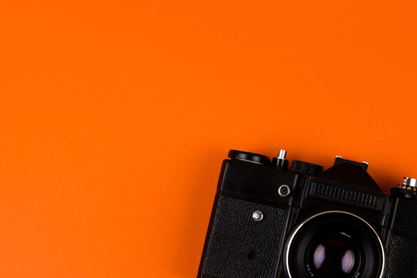 Flat lay film camera isolated on orange background. Copy space - Фото, зображення