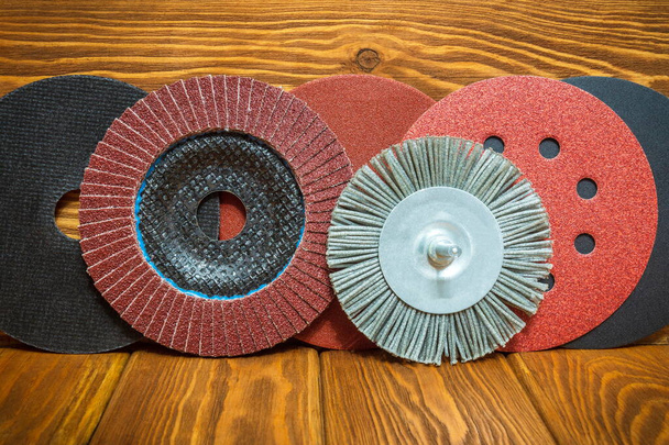Set of abrasive tools and brown sandpaper on vintage wooden boards wizard is used for a grinding items - Photo, Image