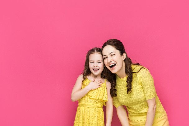 happy mother and daughter laughing isolated on pink  - Photo, Image