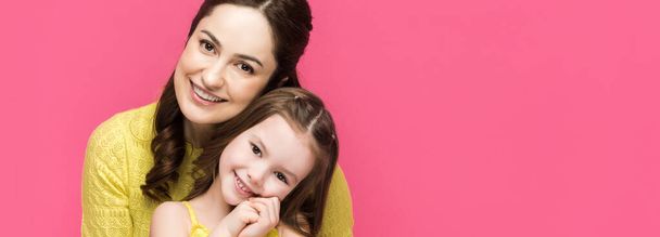 panoramic shot of cheerful mother and daughter isolated on pink  - Photo, Image