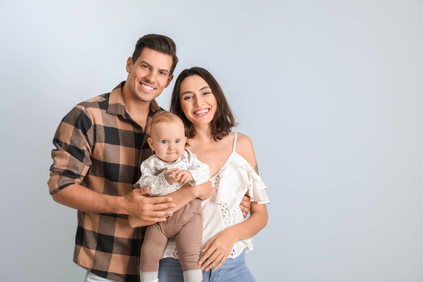 Cute baby with parents on light background - Foto, imagen