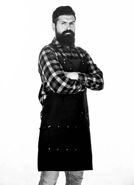 Wrap around design fits him perfectly. Cook with long beard wearing bib apron. Master cook in cooking apron with pockets. Bearded man cook in kitchen apron. Grill cook isolated on white - 写真・画像