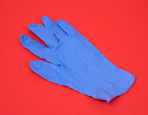 luva de borracha médica azul para a realização de procedimentos e manipulações, sujeito é isolado em um fundo branco
 - Foto, Imagem