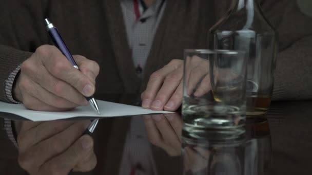 senior man wrinkled hands write on paper sheet with pen - Felvétel, videó