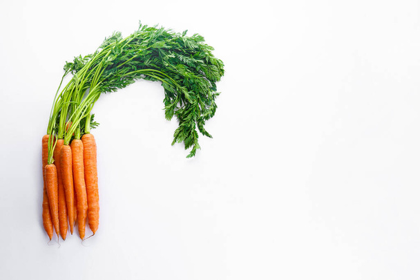 Flat lay composition with ripe fresh carrots on white background. Space for text. - Foto, immagini