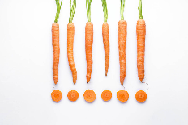 Flat lay composition with ripe fresh carrots on white background - Fotó, kép