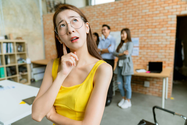 portrait of beautiful confuse asian yellow dress businesswoman thinking and solve business problem meeting room background - 写真・画像