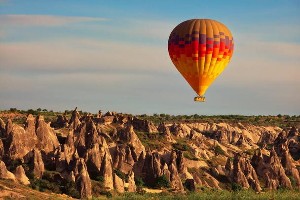 Hot air balloon in the air, popular tourist attraction in Cappadocia, Turkey - Valokuva, kuva