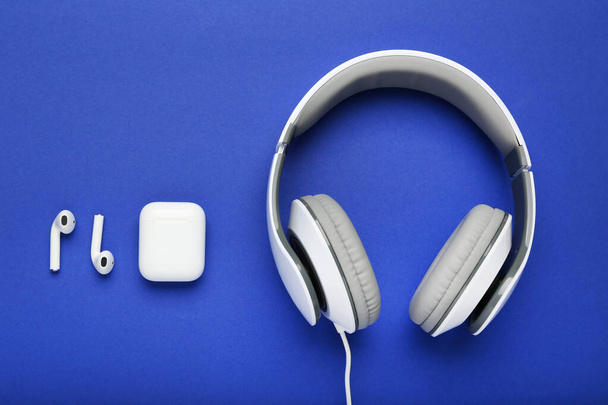 Three different earphones on blue background - Photo, Image