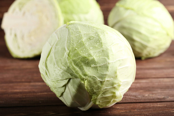 Ripe cabbage on brown wooden table - Foto, Imagem