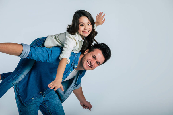 happy father and daughter hugging on white background - Foto, Imagen