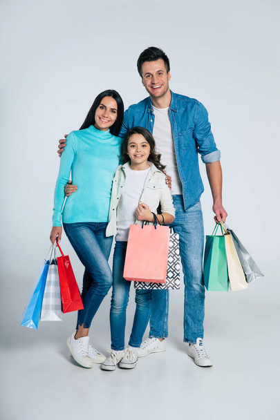 portrait of happy young family with shopping bags - Photo, Image