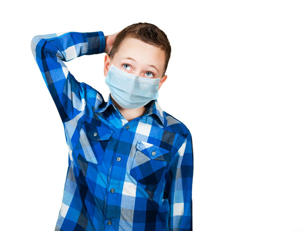 Portrait of thinking boy, wearing a protective face mask prevent virus infection or pollution on white isolated background. - Photo, image