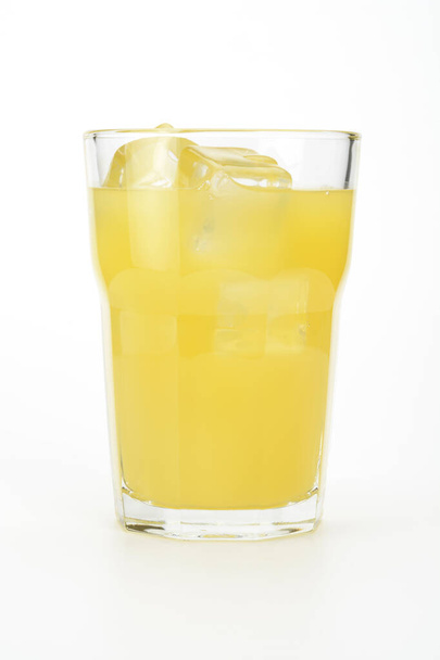 Orange juice in a glass with ice cubes on white background - Foto, afbeelding