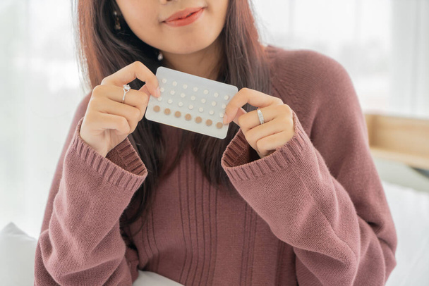 beautiful Asian women holding Birth control pill - Foto, imagen